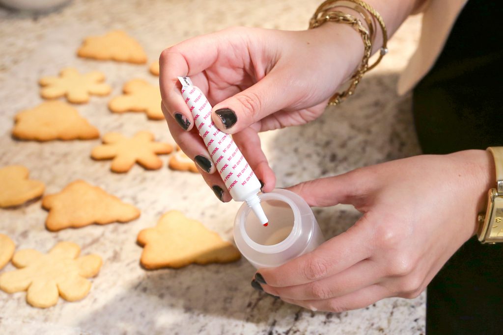 Adding food coloring to homemade icing for christmas sugar cookies ...