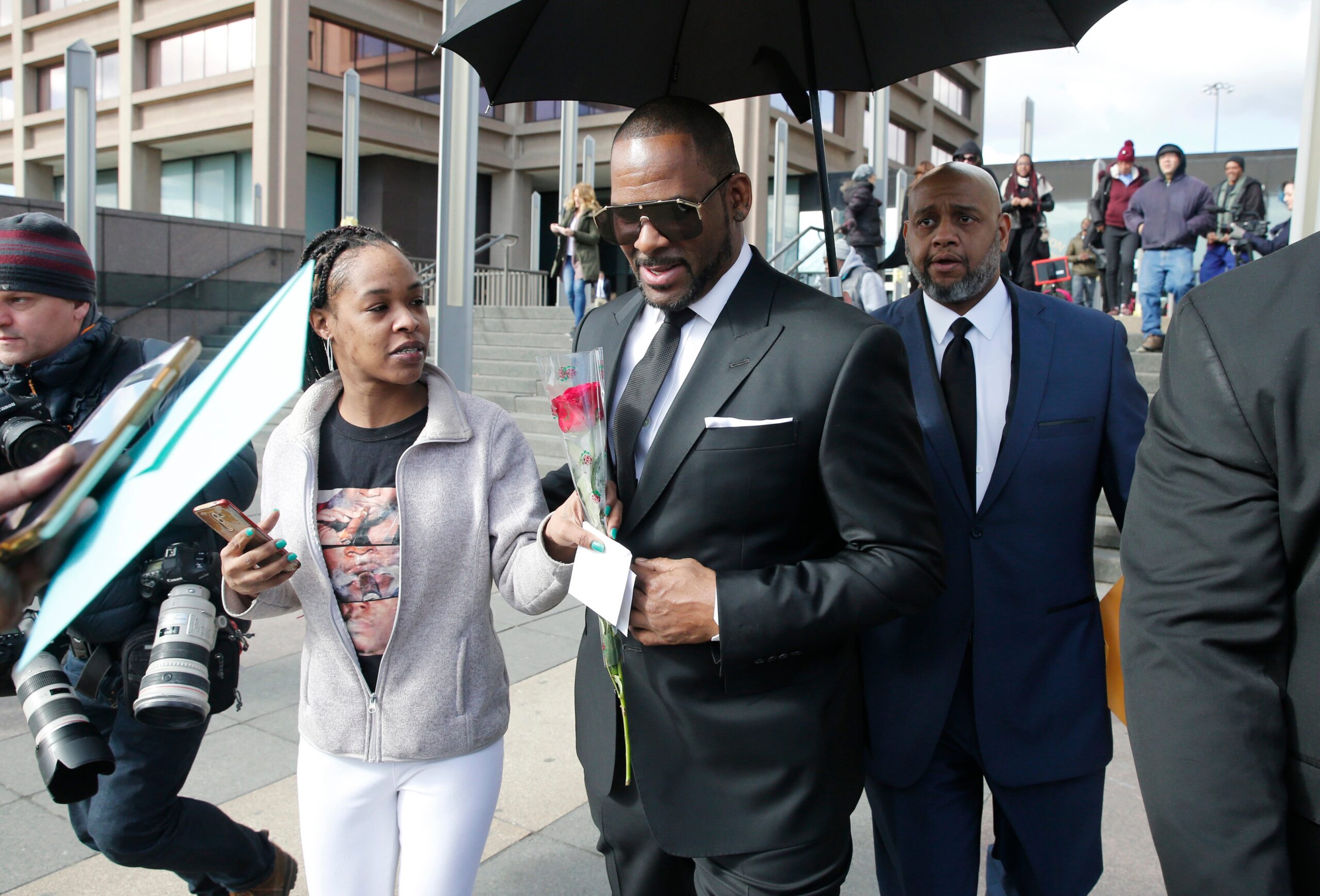 A fan hands singer R. Kelly a rose after his court date at the Leighton Courthouse on March 22, 2019 in Chicago, Illinois. R. Kelly appeared before a judge to request permission to travel to Dubai to work several concerts. Photo: Nuccio DiNuzzo/Getty Images