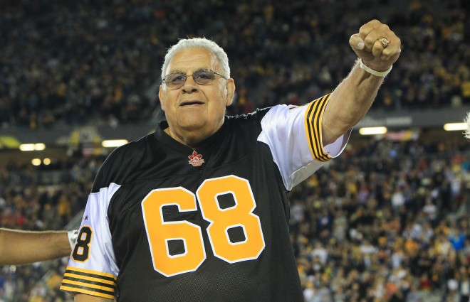 Angelo Mosca reacts to the cheering crowd, during a half-time CFL ceremony in Hamilton on Thursday, Aug. 27, 2015. The Tiger-Cats are retired the former great's jersey #68. (CFL PHOTO - Dave Chidley )