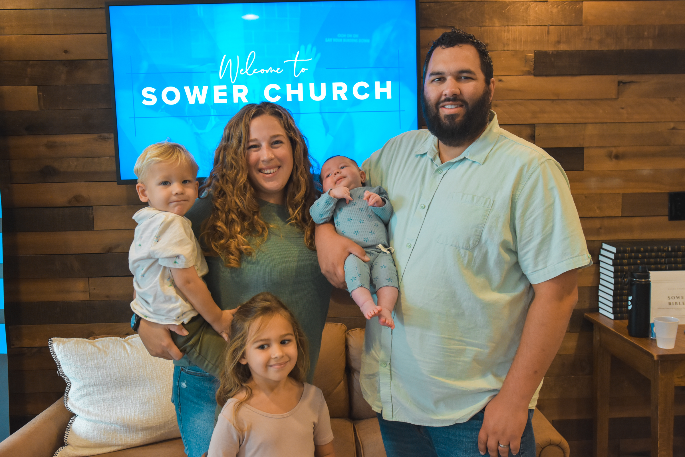 Lovely parents holding their three children at Sower Church.