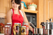 young woman pressure canning