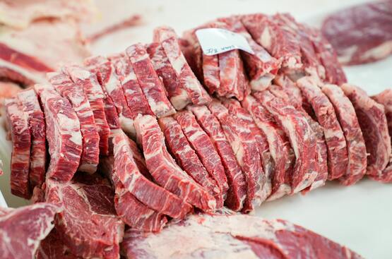 Sliced raw meat on a cutting board.