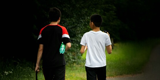 Boys walking on a road
