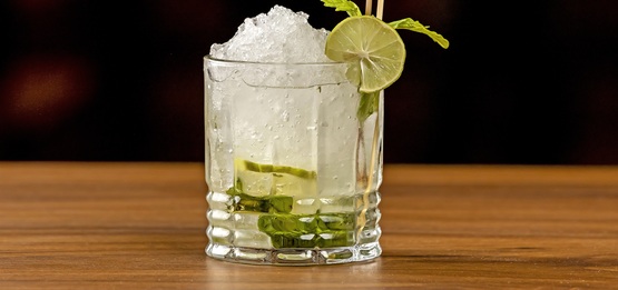 A mocktail with lime and herbs.