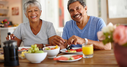 Happy senior couple enjoying a leisurely breakfast together at home.