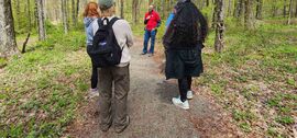 Hikers stopping for a quick break to chat and explore on the trail at Park Station, May 10, 2026.