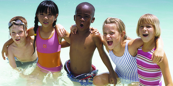 line of kids in the water at summer camp