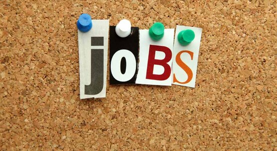 the word "jobs" spelled with push-pins and cut out letters on a cork bulletin board