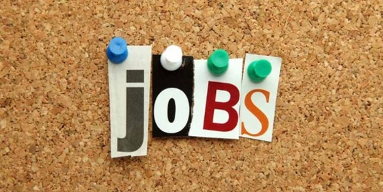 the word "jobs" spelled with push-pins and cut out letters on a cork bulletin board