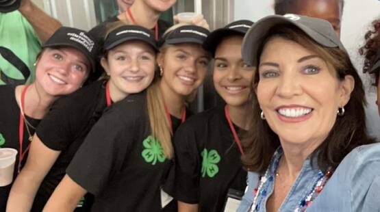 Governor Kathy Hochul takes a selfie with members of the 2024 Milk Bar staff while visiting the Great New York State Fair Dairy Building 
