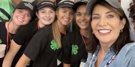 Governor Kathy Hochul takes a selfie with members of the 2024 Milk Bar staff while visiting the Great New York State Fair Dairy Building 