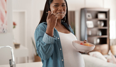 young pregnant african american woman eating healthy