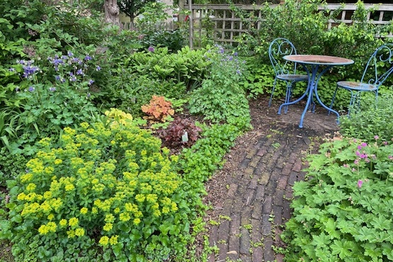 Garden with brick pathway and bistro table