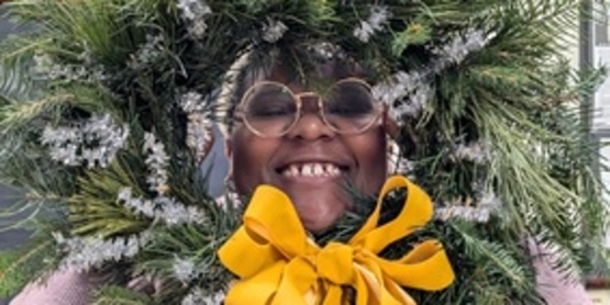 A picture of a participant showing off their wreath