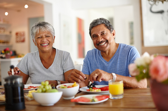 Happy senior couple enjoying a leisurely breakfast together at home.
