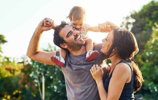 parents and young child enjoying a sunny day