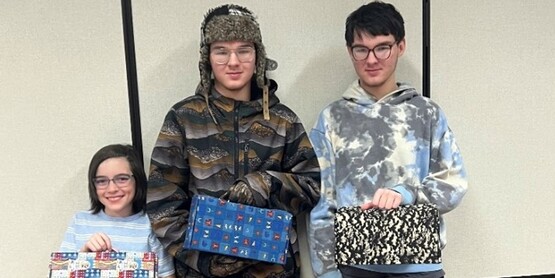 Three participants of the Leaf Jr. Sewing Box class show off their new sewing kits. Pictured are Colton Reynolds with Aiden and Cayden Novaro.