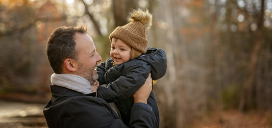 parenting holding children outside in fall