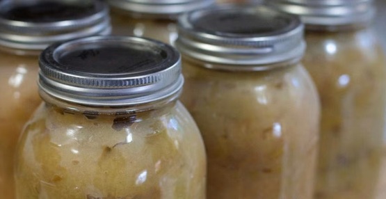 A picture of several canning jars filled with applesauce
