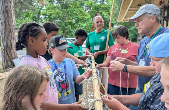 Campers practicing knot tying.