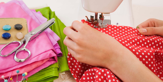 Photo of woman's hands using sewing machine