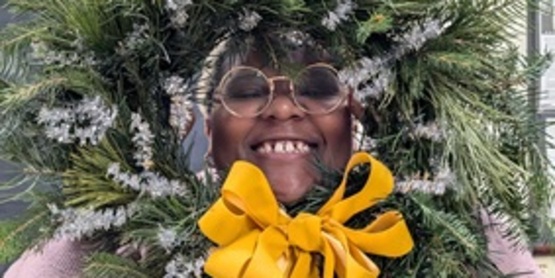 A picture of a participant showing off their wreath