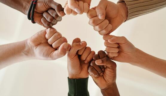 Group of hands in a circle.