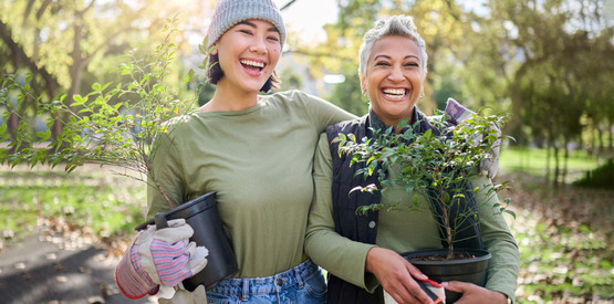 Young and older woman gardening in a community park, Adobe Stock license