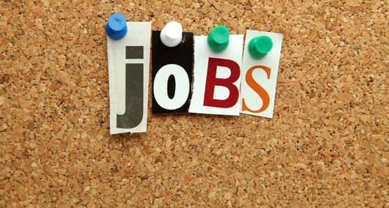 the word "jobs" spelled with push-pins and cut out letters on a cork bulletin board