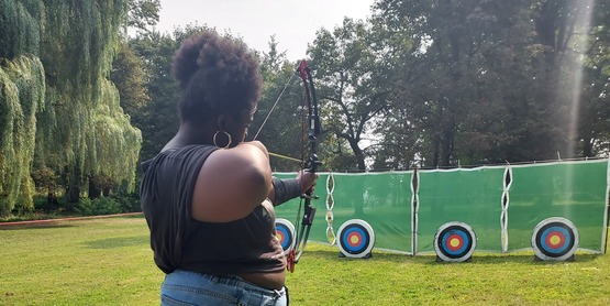 Youth shooting bow at target