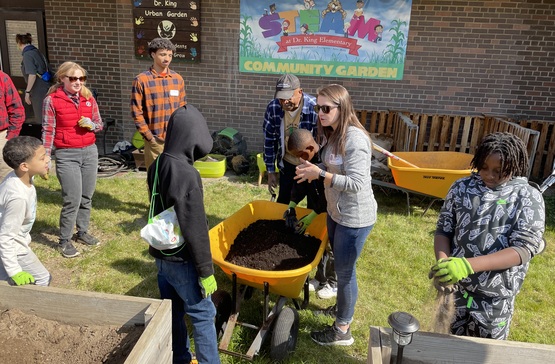Youth planting strawberries