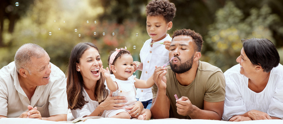 hispanic family blowing bubbles