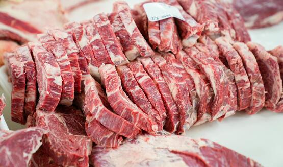 Sliced raw meat on a cutting board.