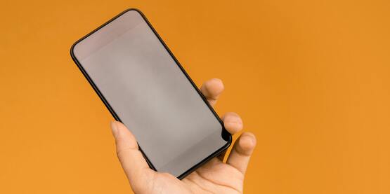 cell phone in teens hand