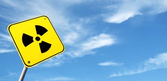 Radioactivity sign against a blue sky, for use on Radon education events