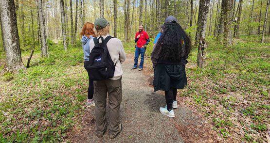 Hikers stopping for a quick break to chat and explore on the trail at Park Station, May 10, 2026.