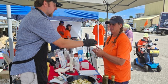 Fisheries Technician Tyler Guteres serving up sauteed monkfish bites as part of our Choose Local F.I.S.H. initiative