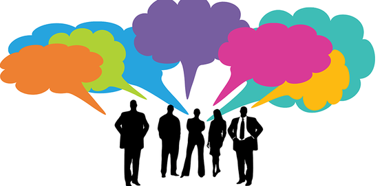 group of business people in silhouette with multi colored speech bubbles