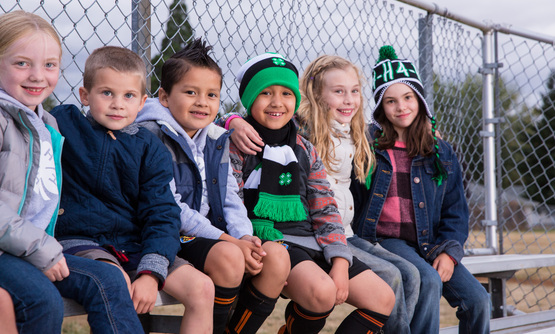 Children sitting on bleachers