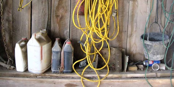 oil and other chemical products on a shelf in a barn