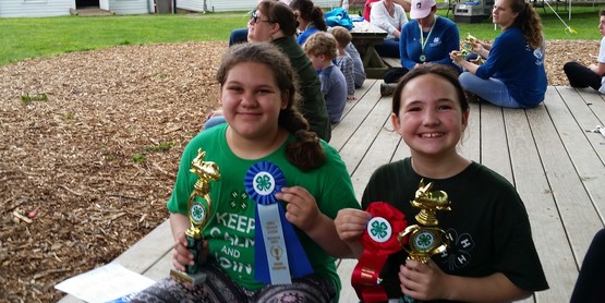 Ava and Molly with trophies.