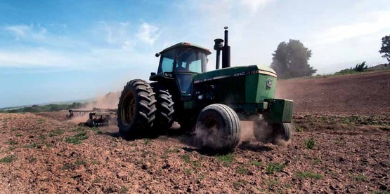 A tractor turns the cover crop into the soil in preparation for planting at Leafy Greens, a farm in the Salinas Valley of California. USDA Photo by Lance Cheung.