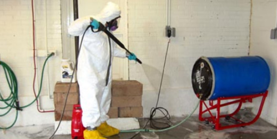 Using a pressure washer to clean contaminated surfaces; photo from FEMA publication "Initial Restoration for Flooded Buildings".