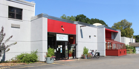 Exterior of CCE Tompkins building at 615 Willow Avenue in Ithaca NY showing new greenhouse assembled summer 2021.
