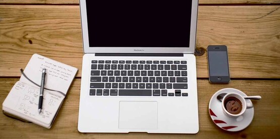 notebook, computer, phone, cup of coffee; desk