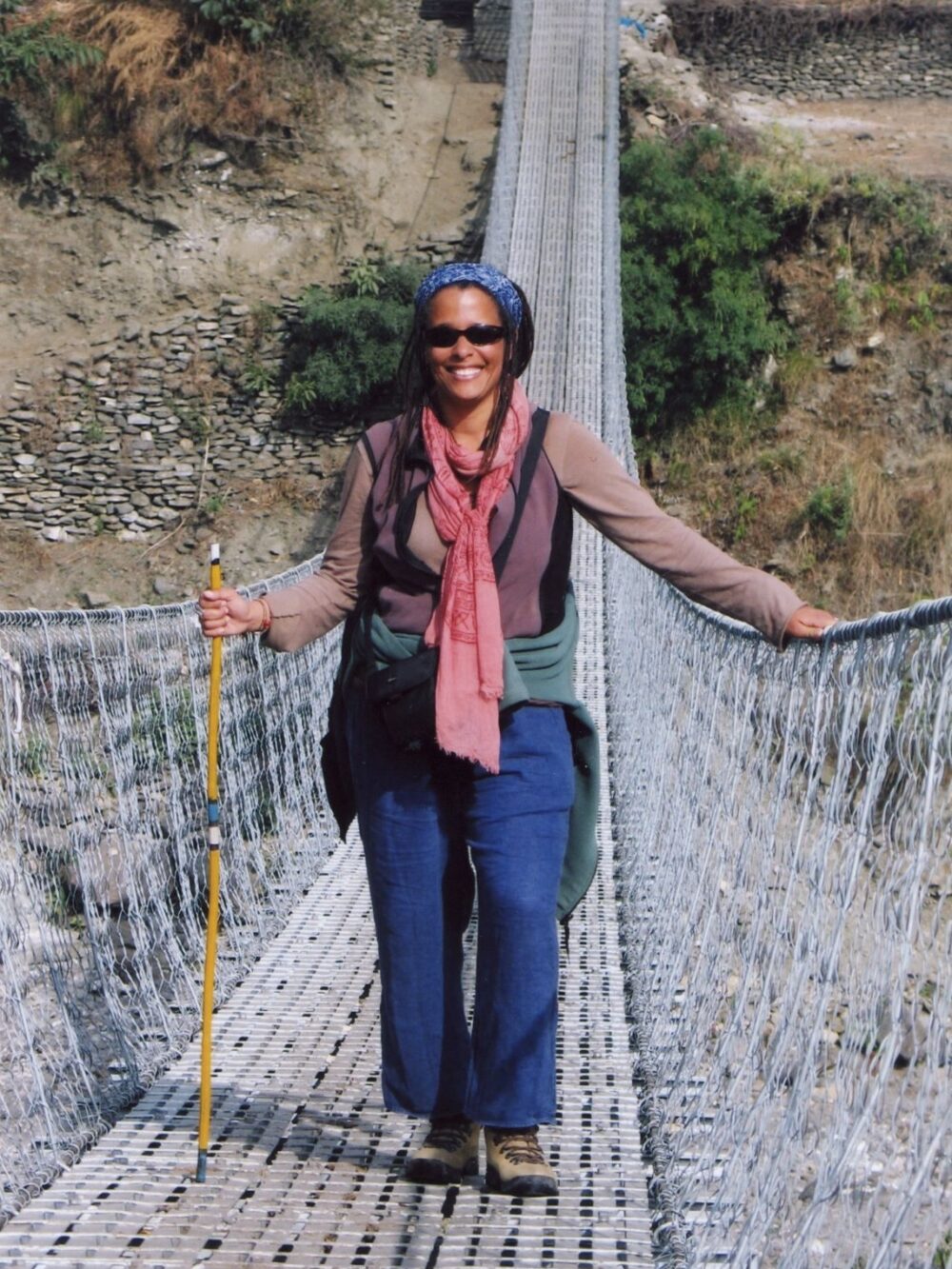 Dr. Finney crossing a rope bridge in Nepal