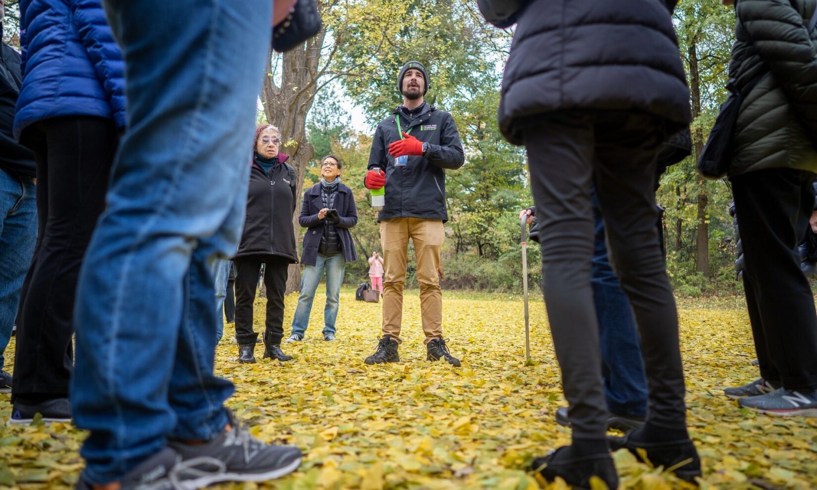A Conservancy tour guide speaks to a circle of tour goers.
