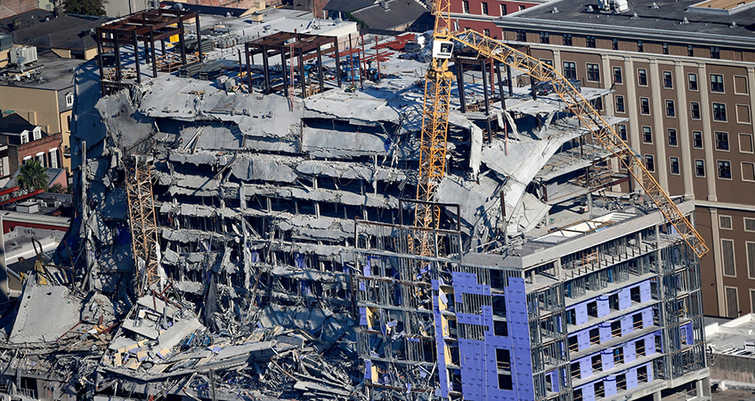 Demolition crews used explosives to try to safely take down the cranes, which were each more than 250 feet (76 meters) tall, from the building’s damaged shell.