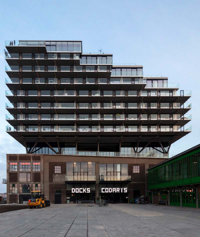 The converted warehouse is divided in two by a central corridor that serves as an entrance lobby to the apartments above.