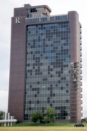 A tornado badly damaged Remington Tower, an office hub, in 2017, but the project is undergoing a residential revitalization.  Image Credit: Ian Maule/Tulsa World.